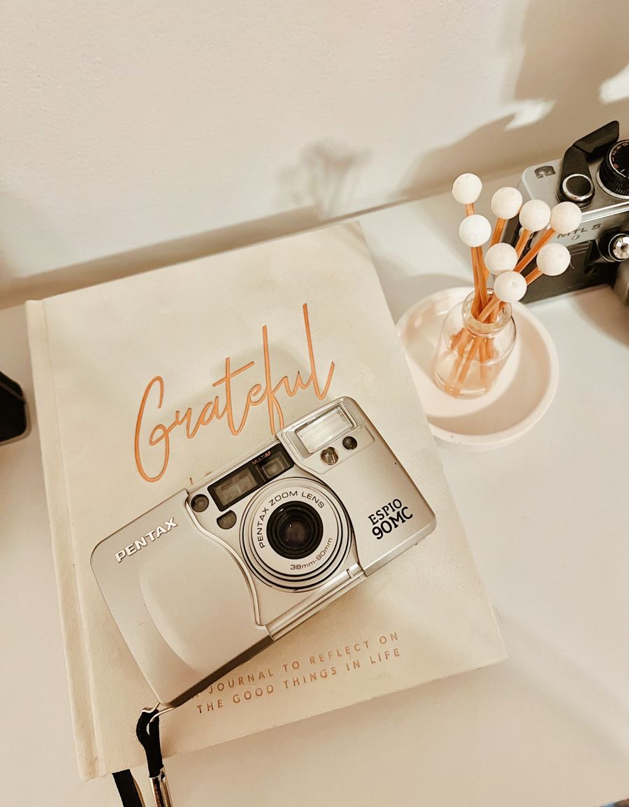 a cute decorative camera with a decorative label on a table