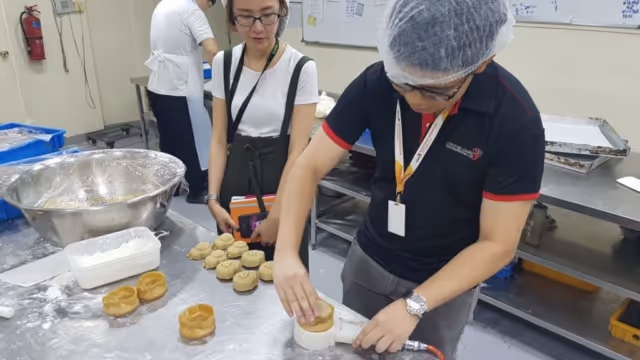 Ms. Nijie and Mr. Zhisheng having a go at making mooncakes with 3D printed molds.