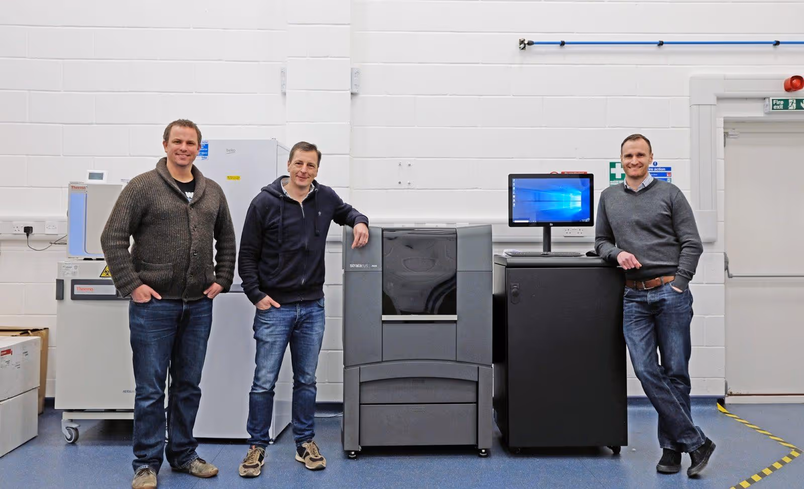 Dr Colin Barker, Richard Vellacott and Nick Rollings (left to right) standing next to Stratasys J826