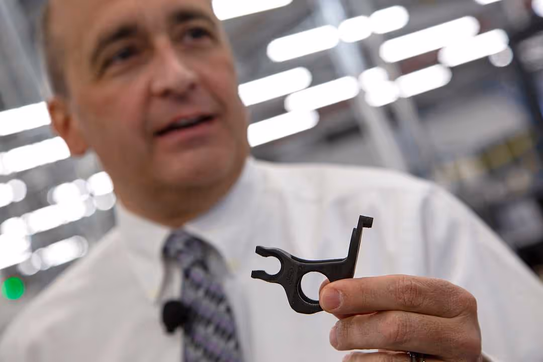 Harold Sears, additive manufacturing technical leader at Ford’s Advanced Manufacturing Center, holding the 3D printed brake bracket of the Mustang GT500. (Photo: Mandi Wright, Detroit Free Press)