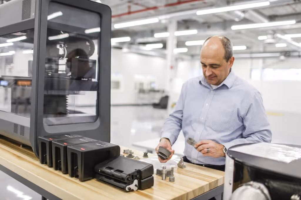 Harold Sears, additive manufacturing technical leader at Ford’s Advanced Manufacturing Center, studies 3D printed parts printed with Desktop Metal's Studio System+.
