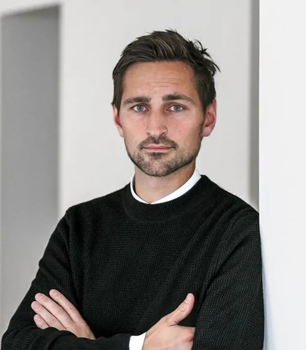Man smiling in black shirt