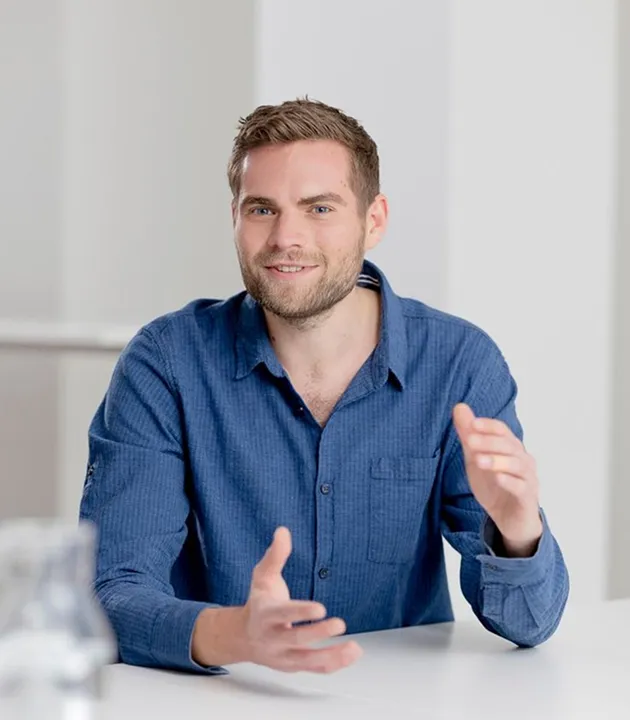 Man smiling in dark blue shirt