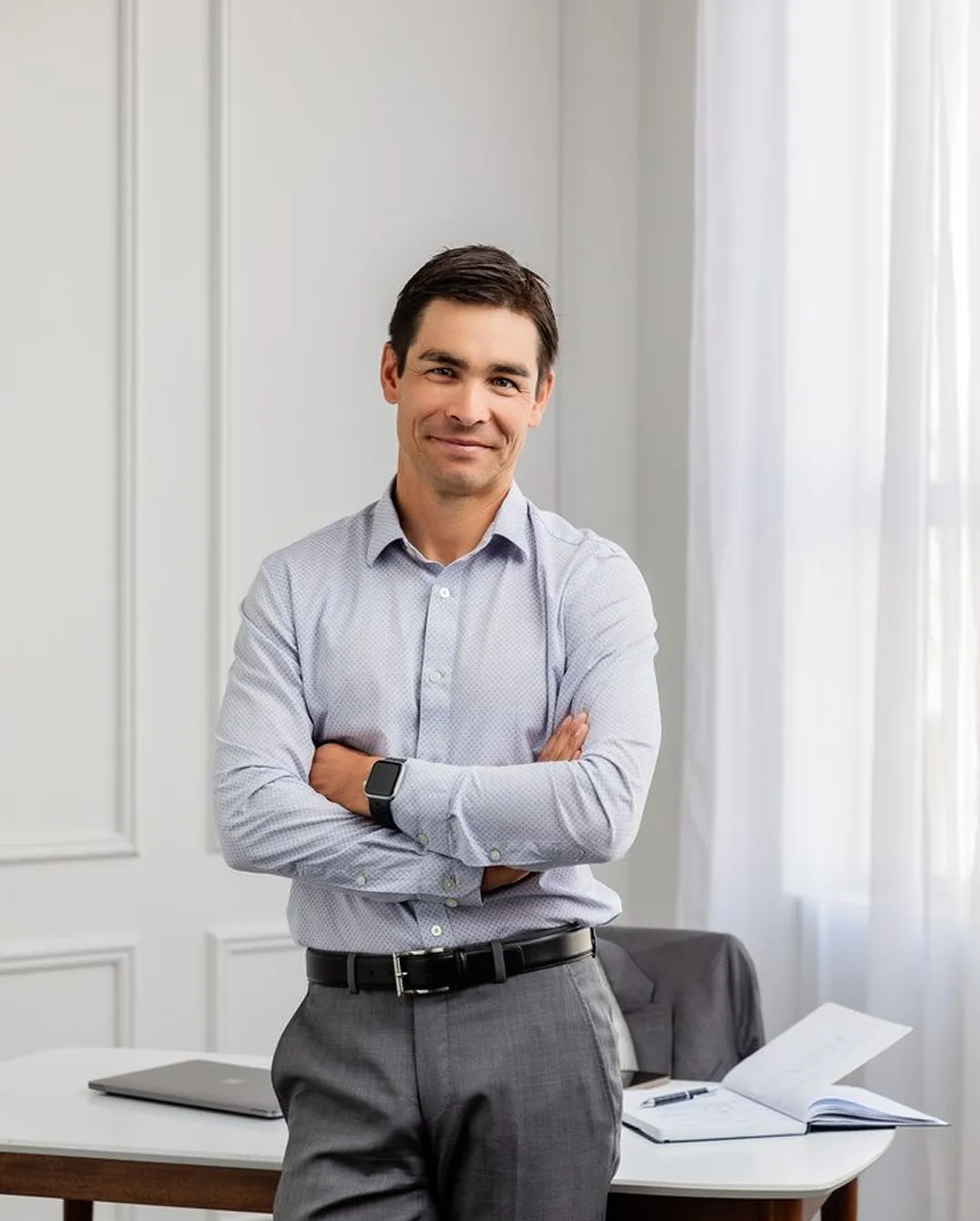 Man smiling in light blue shirt