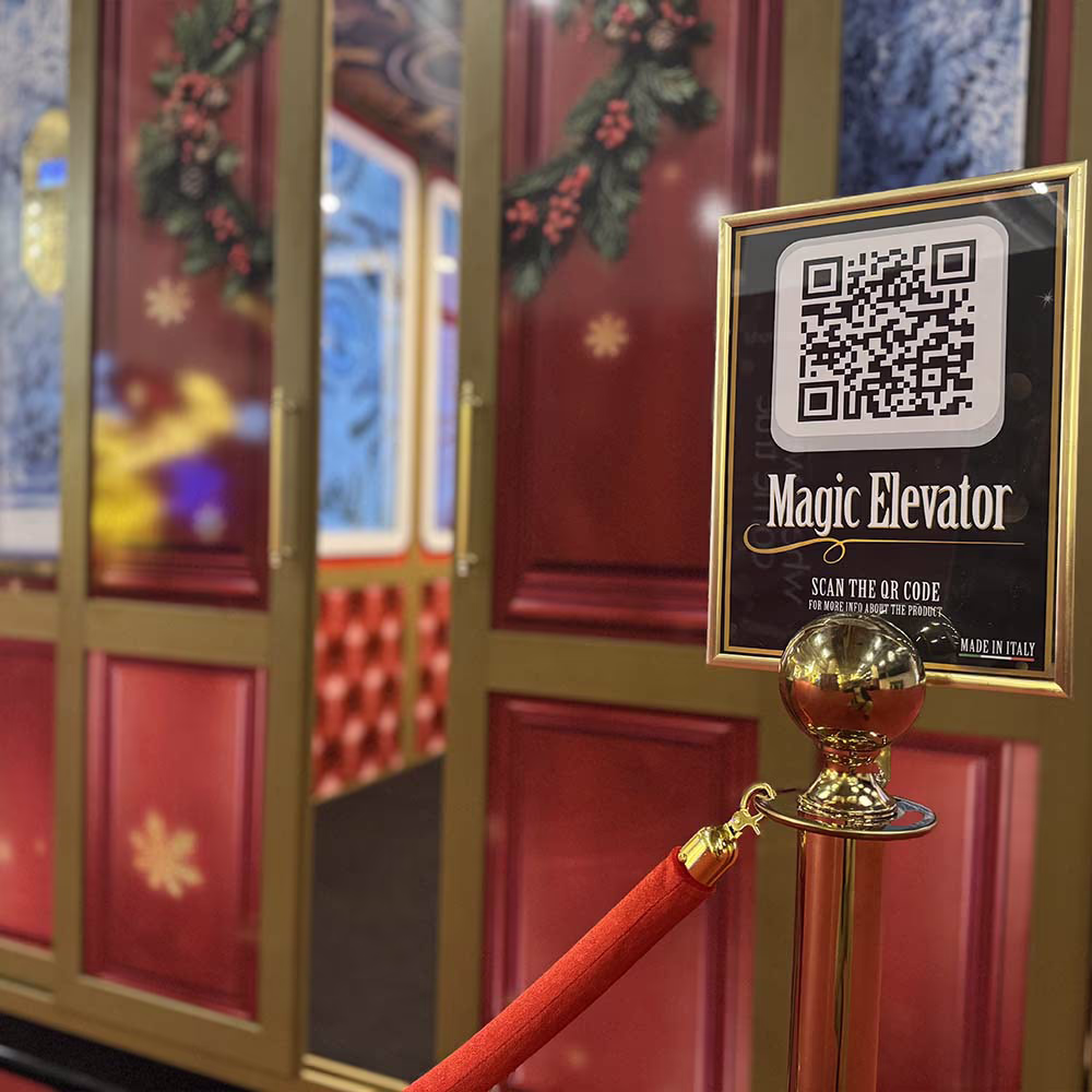 Elevator entrance decorated with Christmas wreaths and a sign with QR code and Magic Elevator text.