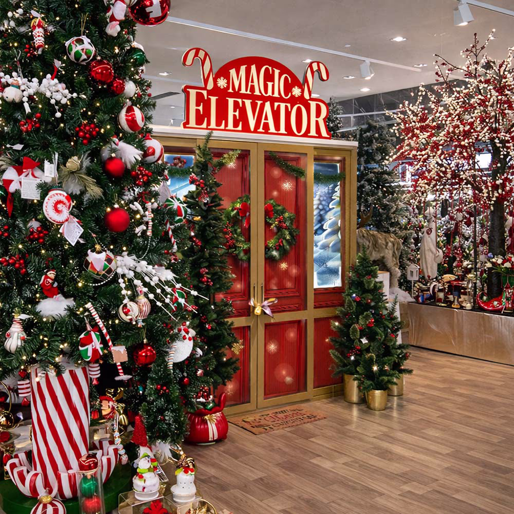 Christmas-themed entrance of a magical elevator with Christmas trees and red and green decorations.
