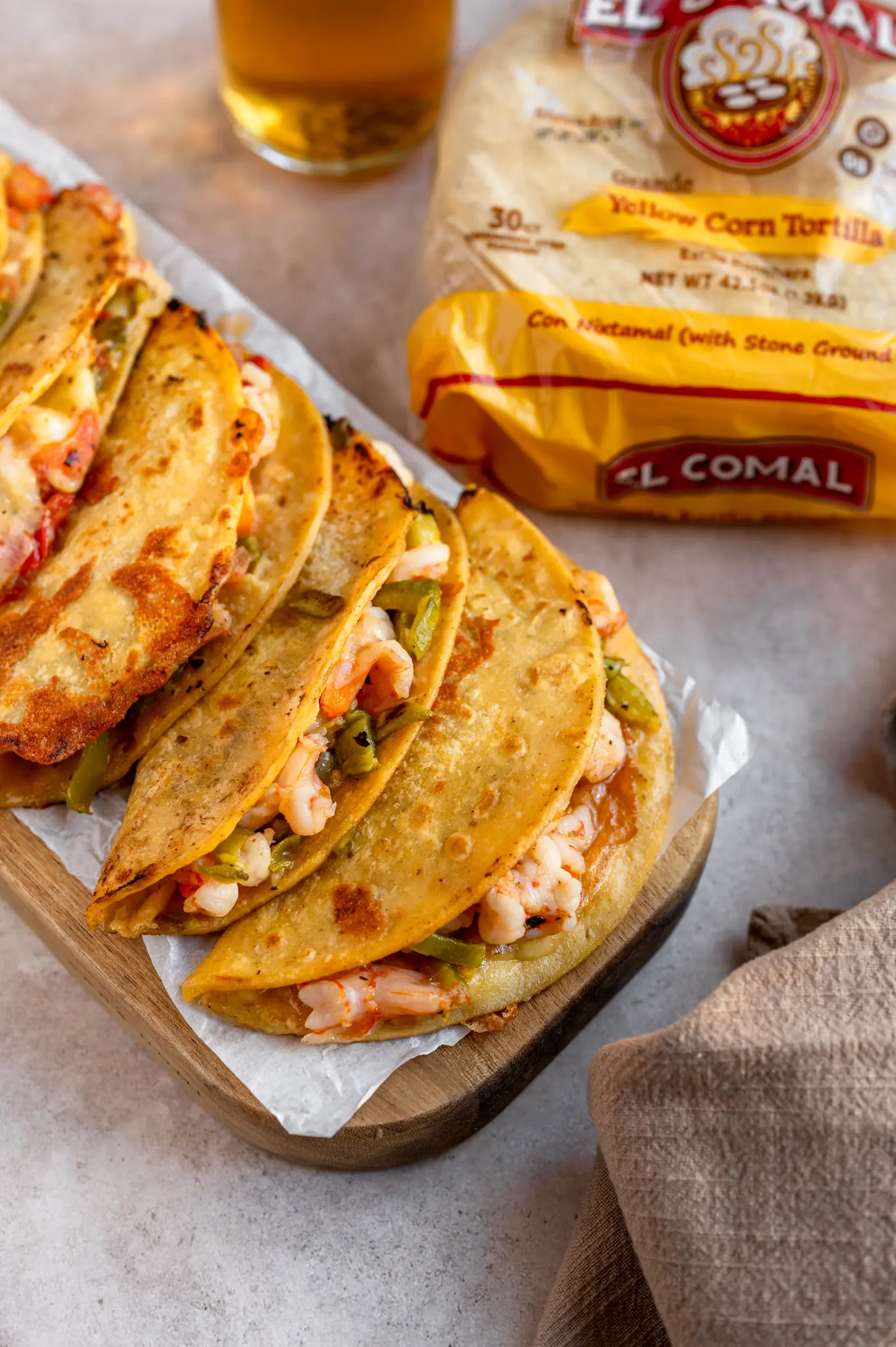 Shrimp tacos with bell peppers and onions in corn tortillas