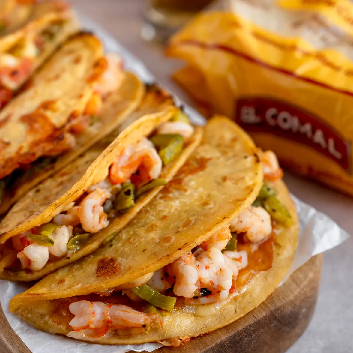 Shrimp tacos with bell peppers and onions in corn tortillas