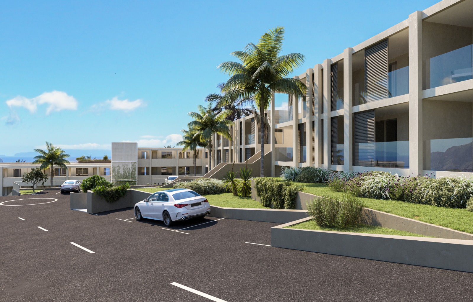 Vista desde a estrada da fachada do complexo habitacional, com estilo moderno e varandas envidraçadas e elementos de betão que enquadram cada apartamento. Árvores e zonas verdes fazem um intervalo entre a fachada e a estrada com alguns carros estacionados.