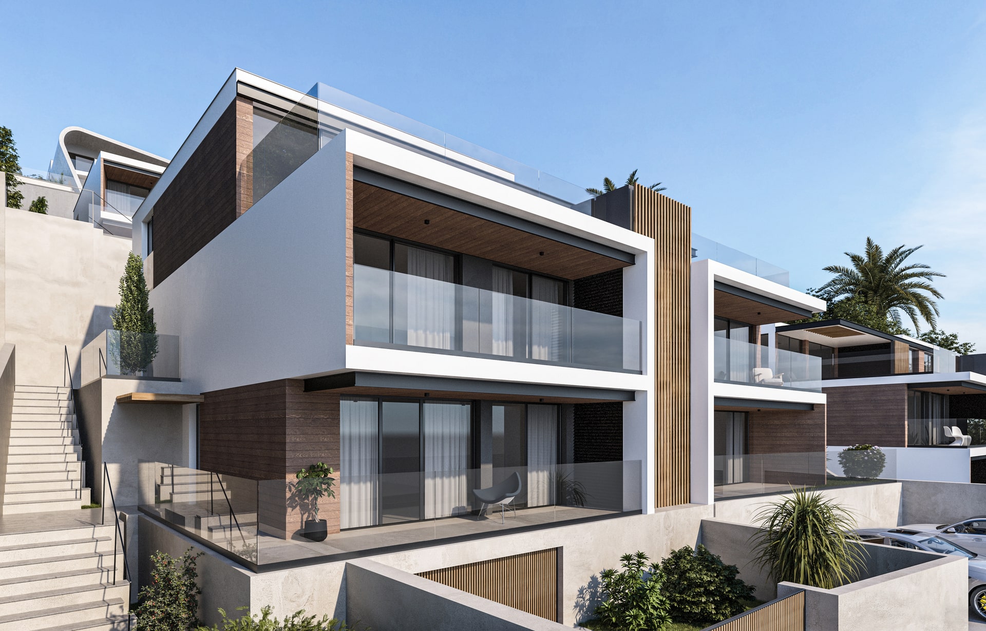 Um conjunto de casas modernas e luxuosas em socalcos numa encosta. As casas têm grandes janelas, varandas com parapeitos de vidro e detalhes em madeira, com um caminho pedonal e vegetação ao longo da encosta.