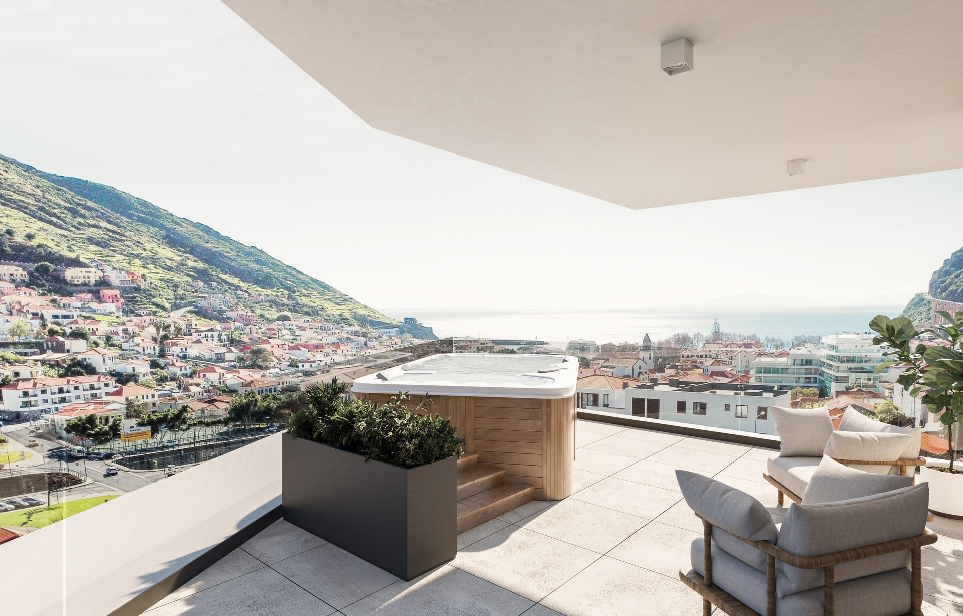 Terraço coberto com vista panorâmica para uma cidade e montanhas, mobiliado com sofá, poltrona e plantas, incluindo uma banheira de hidromassagem