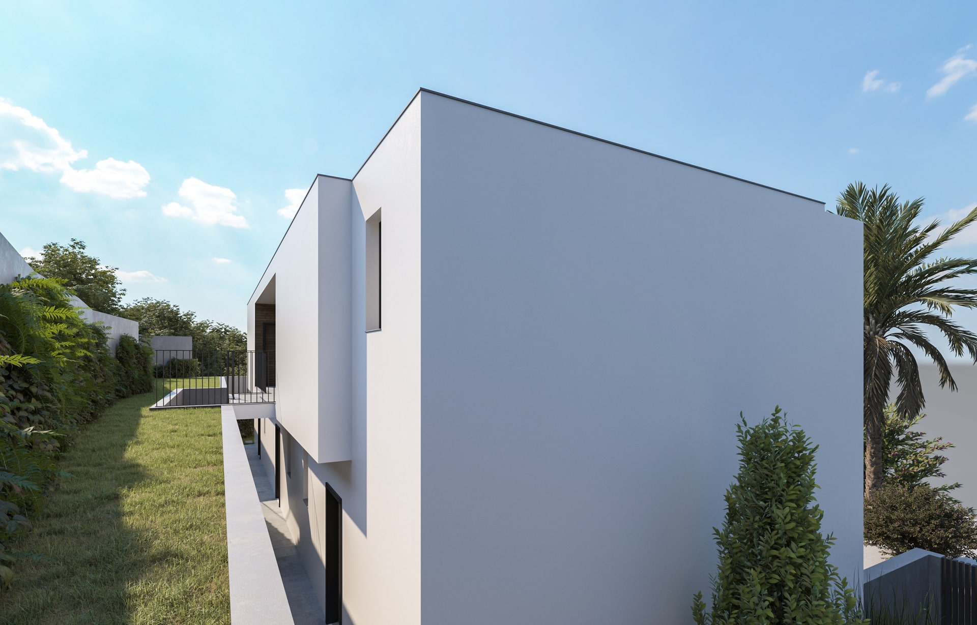 Fachada lateral de uma casa moderna de dois andares, com paredes brancas e linhas retas, cercada por um jardim gramado e vegetação densa ao lado, em um dia ensolarado.
