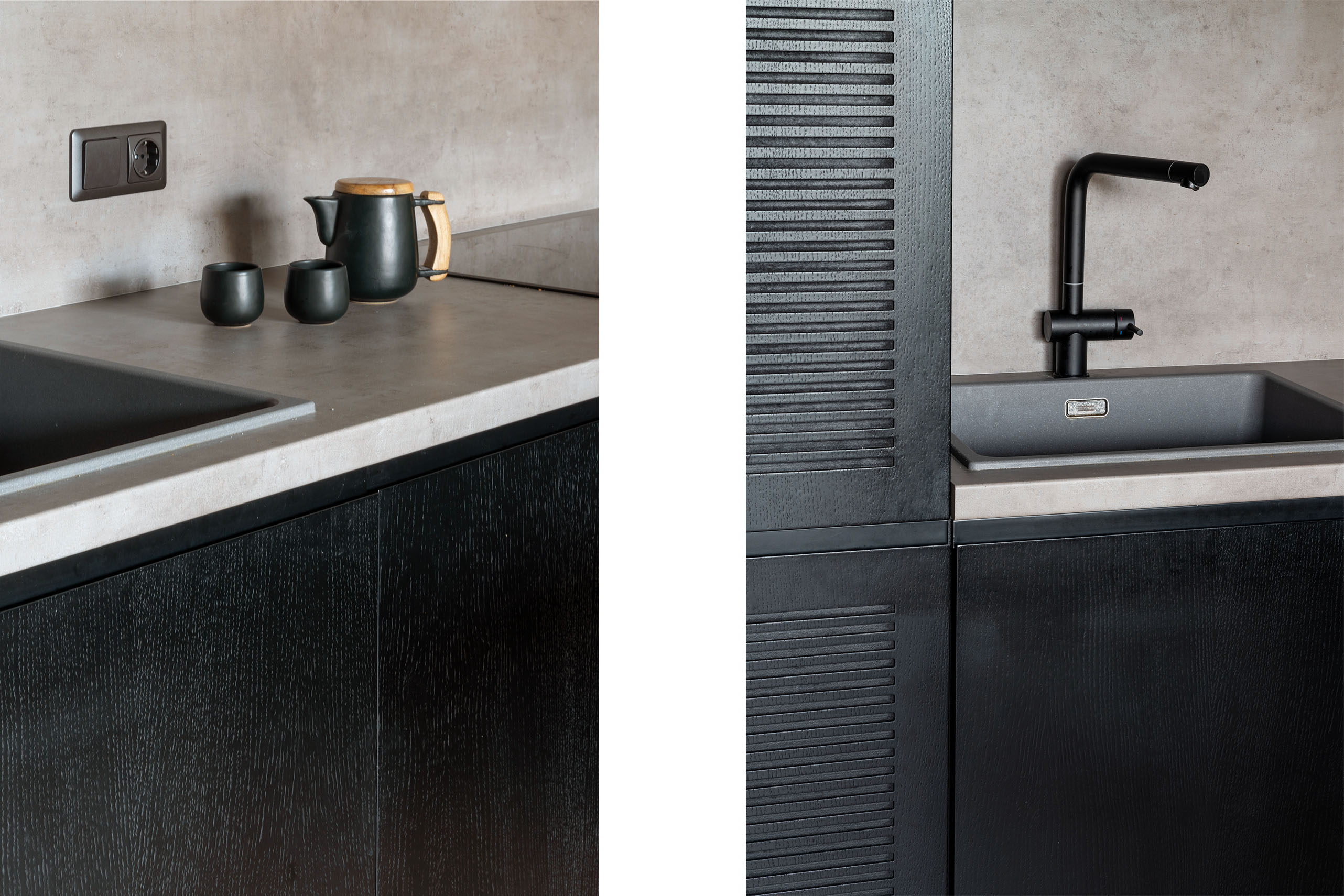Detail einer Betonarbeitsplatte mit schwarzem Spülbecken und einem minimalistischen Keramik-Teeset. Nahaufnahme eines schwarzen lamellierten Küchenschranks neben einem grauen Spülbecken und einer Betonrückwand.