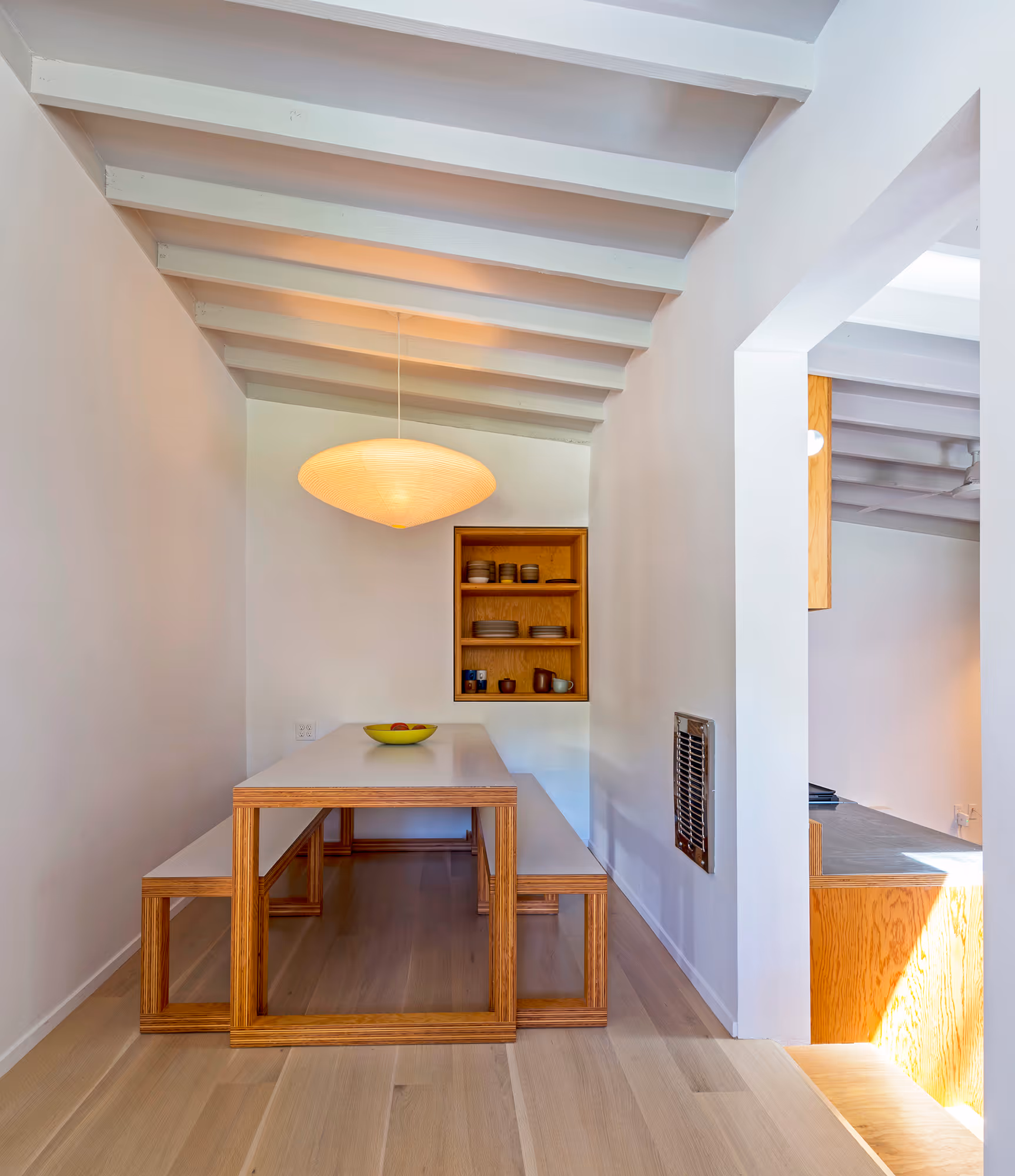 dining room with custom table, bench, and built-in niche