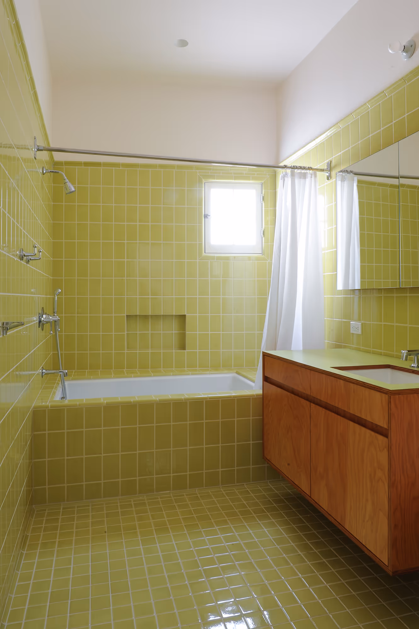 bathroom with green tile and custom vanity