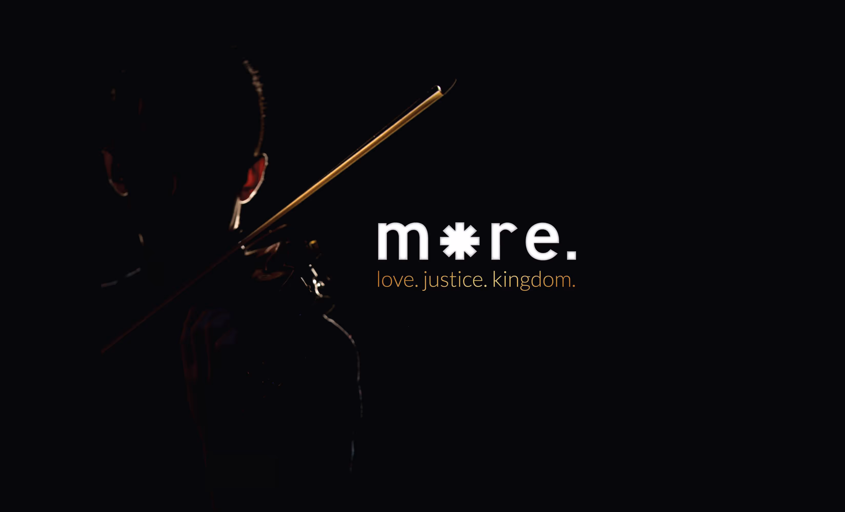 Social media tile for More Conference 2018 of a person holding a violin with very low light.