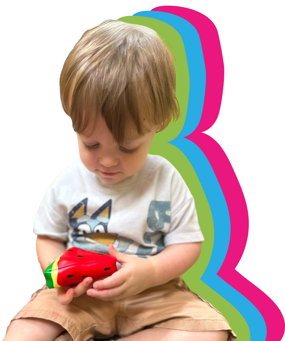 young child playing with a watermelon toy