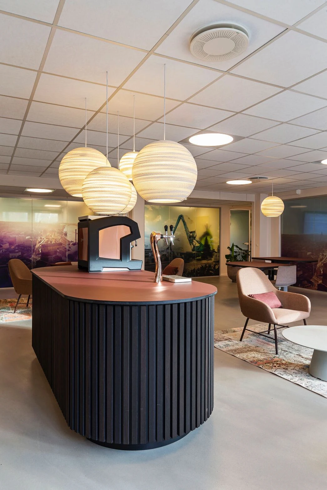 Hand selecting the latte option on a touchscreen coffee machine in a cafe setting.