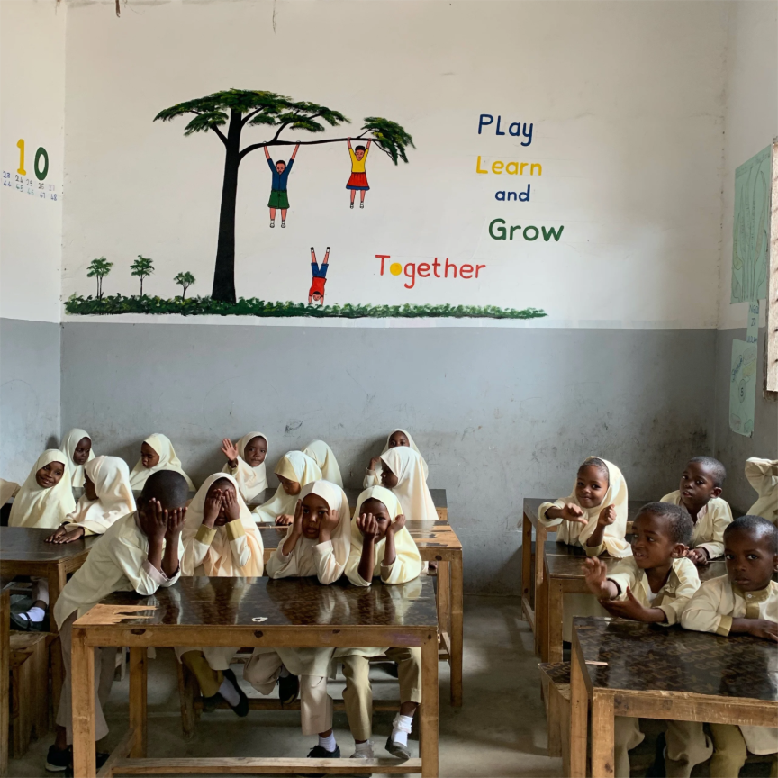 A group of children sitting at desks in a classroomAI-generated content may be incorrect.