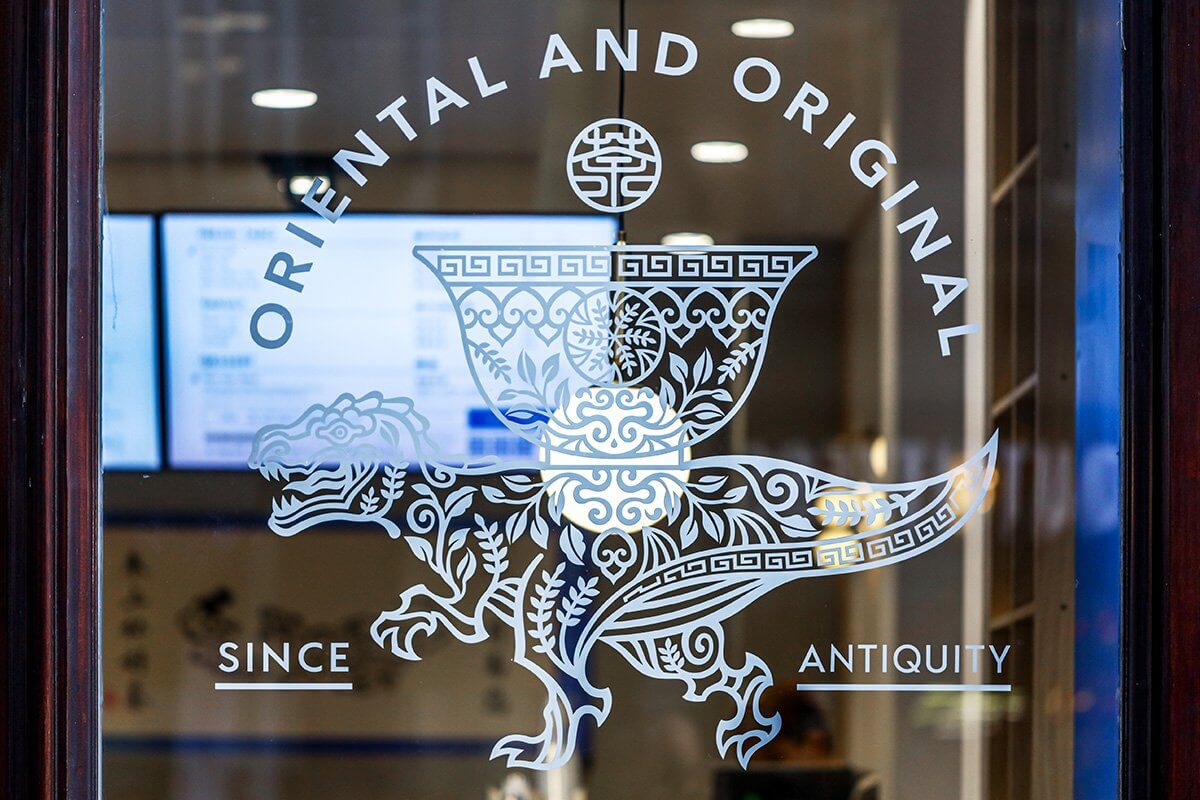 Close-up of Oricha Logo on Glass Window