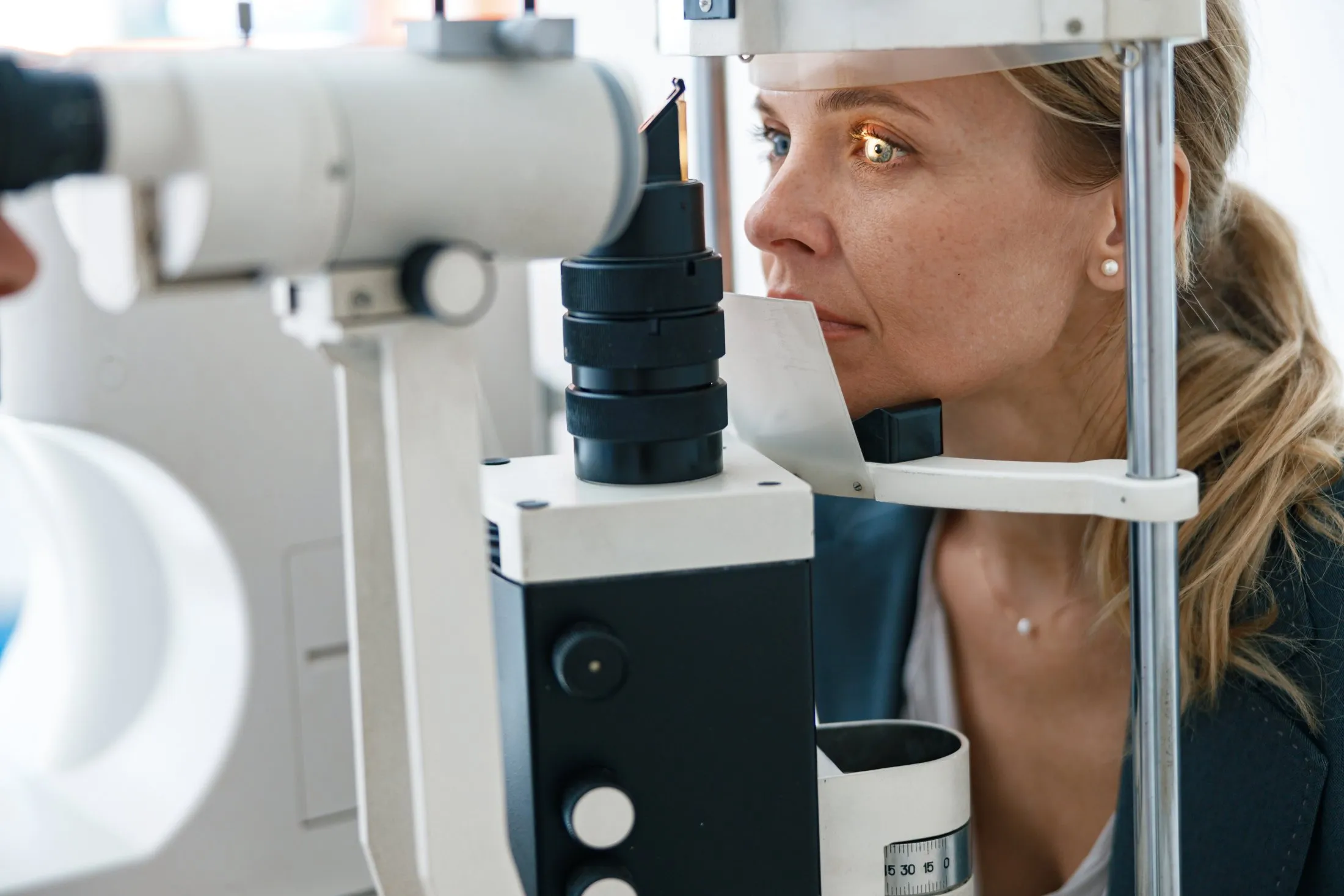 Patient undergoing eye exam with professional optometry equipment