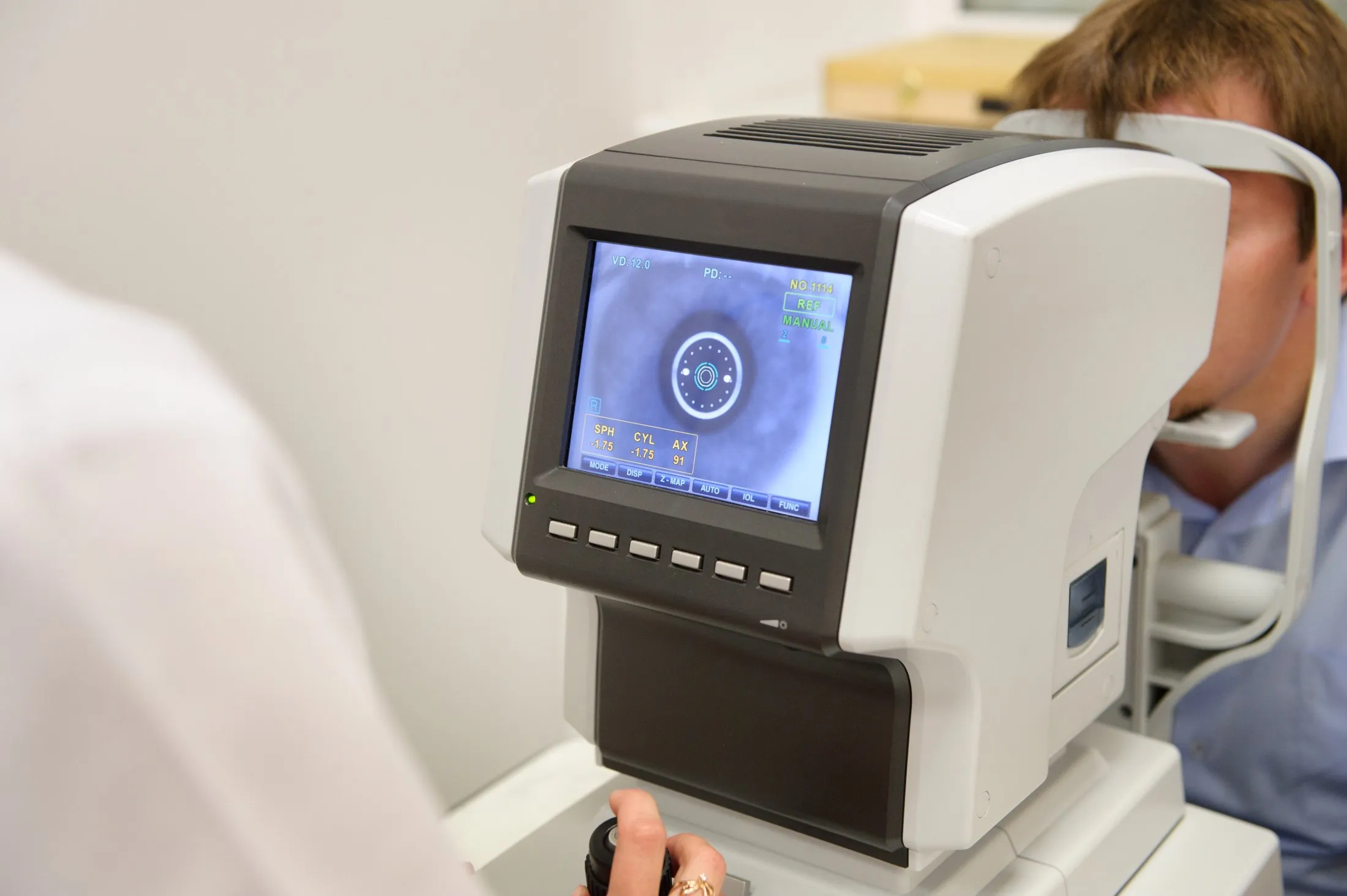 Eye exam machine showing detailed retinal scan on digital screen
