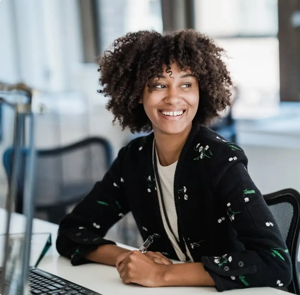 A woman sitting in front of a laptop computer.