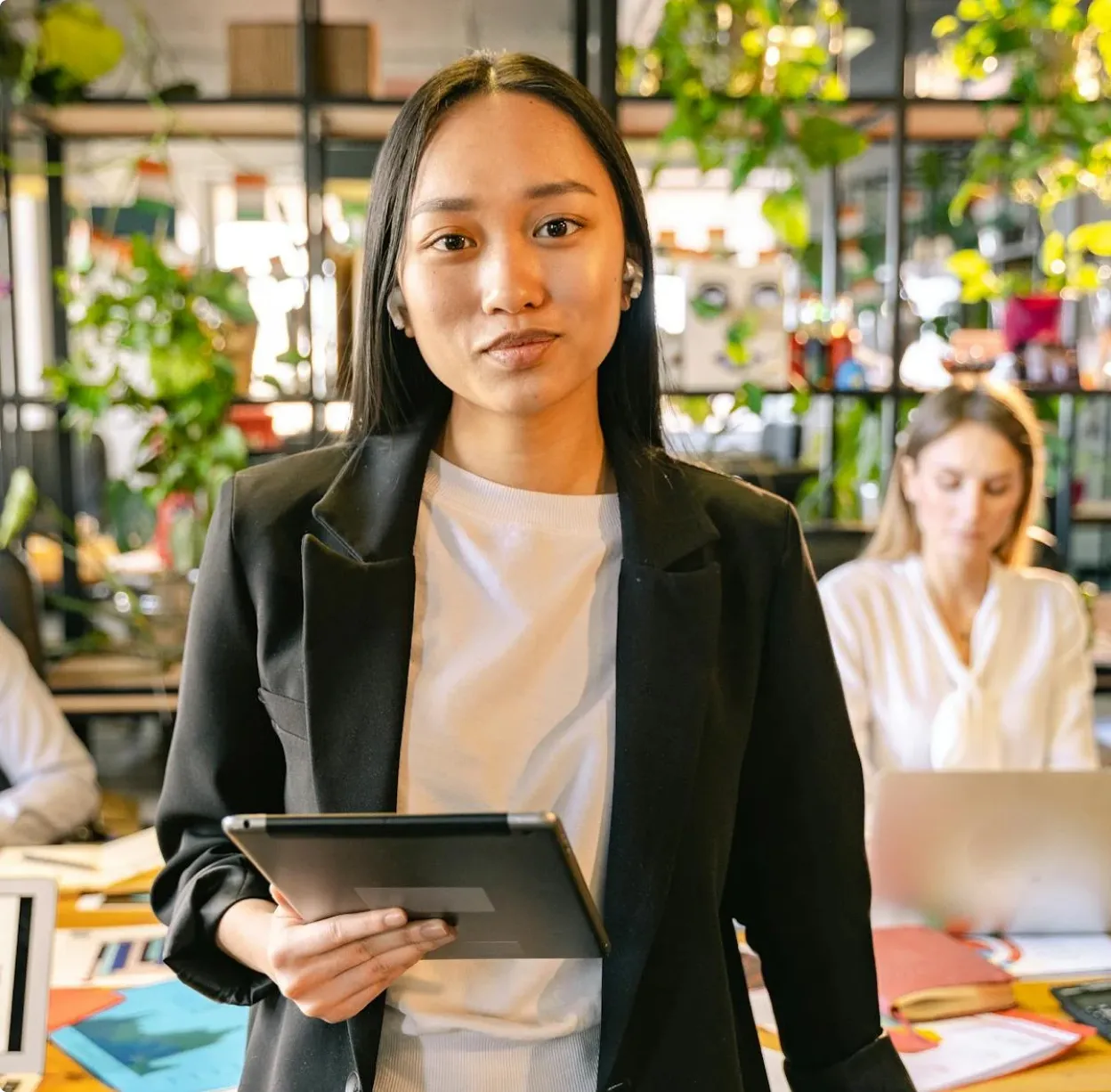 A woman standing in front of a laptop computer.