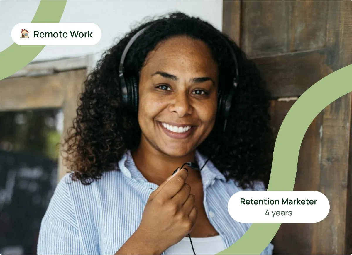 A woman with headphones is smiling for the camera.