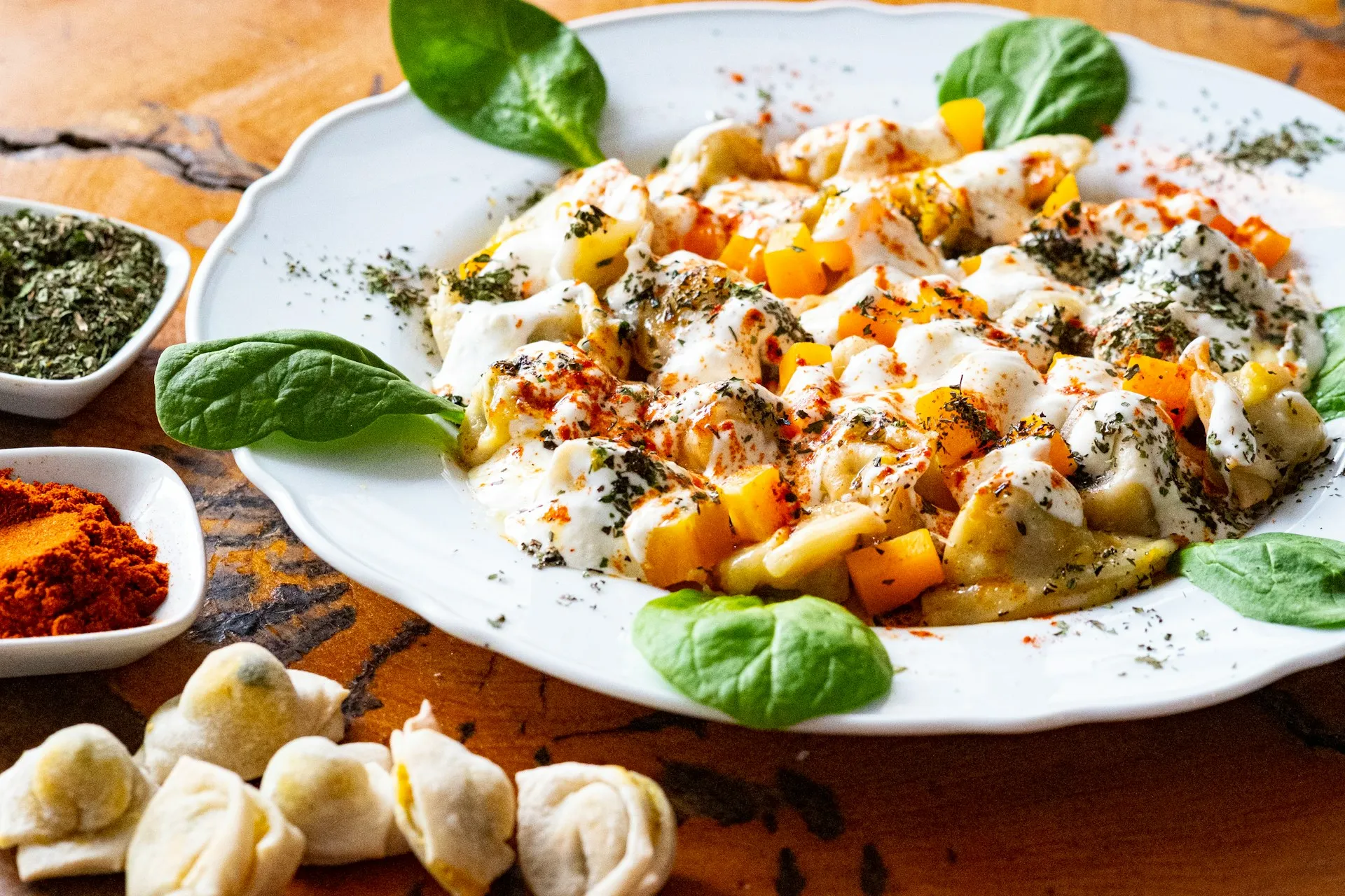A plate of ravioli with spinach and cheese.
