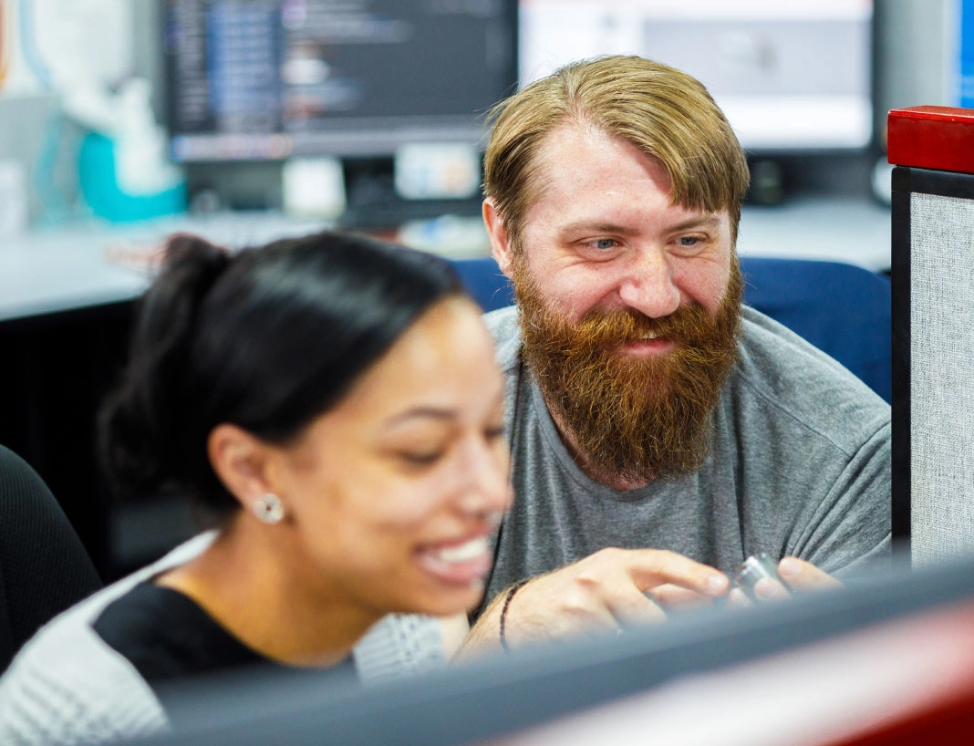 Two LockNet team members collaborating at computer in office