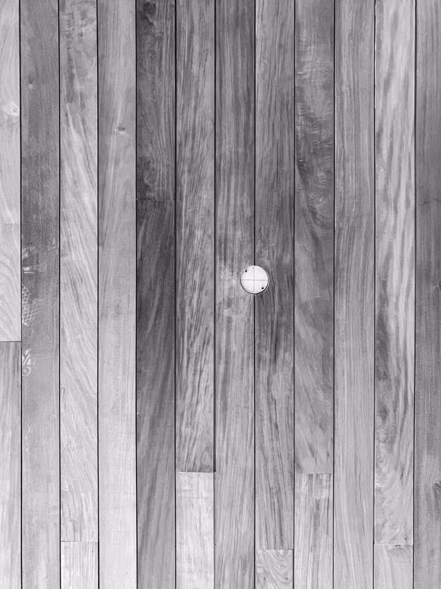 Natural wood door with metal handle and textured wood grain detail.