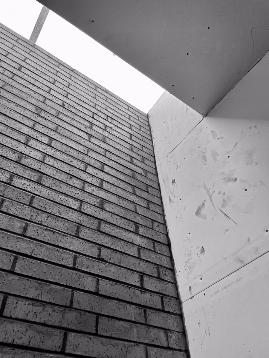 Exterior construction site details featuring brick wall and concrete panel building components installation.