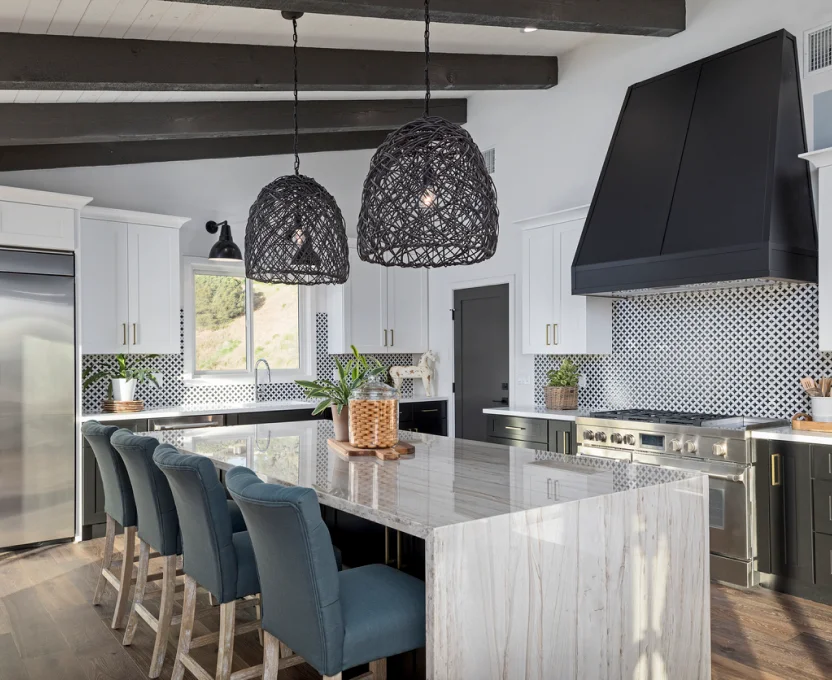 Modern kitchen with large island blue chairs woven pendant lights and patterned backsplash