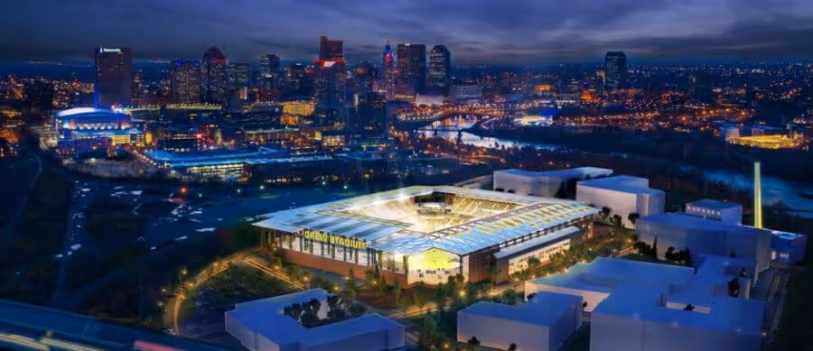 Aerial view of the Columbus Crew soccer arena illuminated at night.
