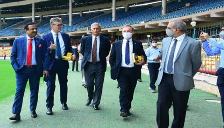 Group of men in business attire touring a SubAir stadium installation in India.