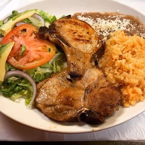 A plate of food with meat and vegetables.