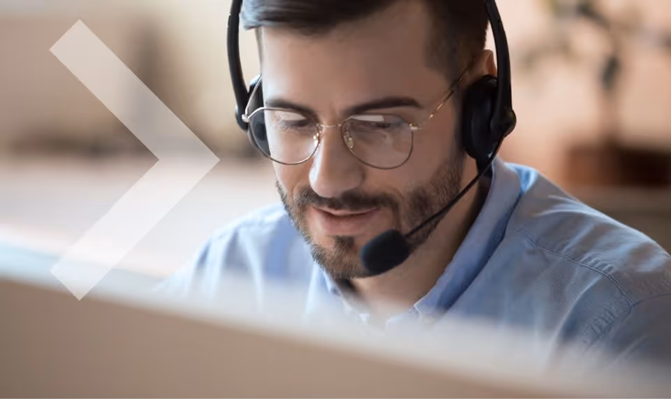 A customer support worker working on his computer.