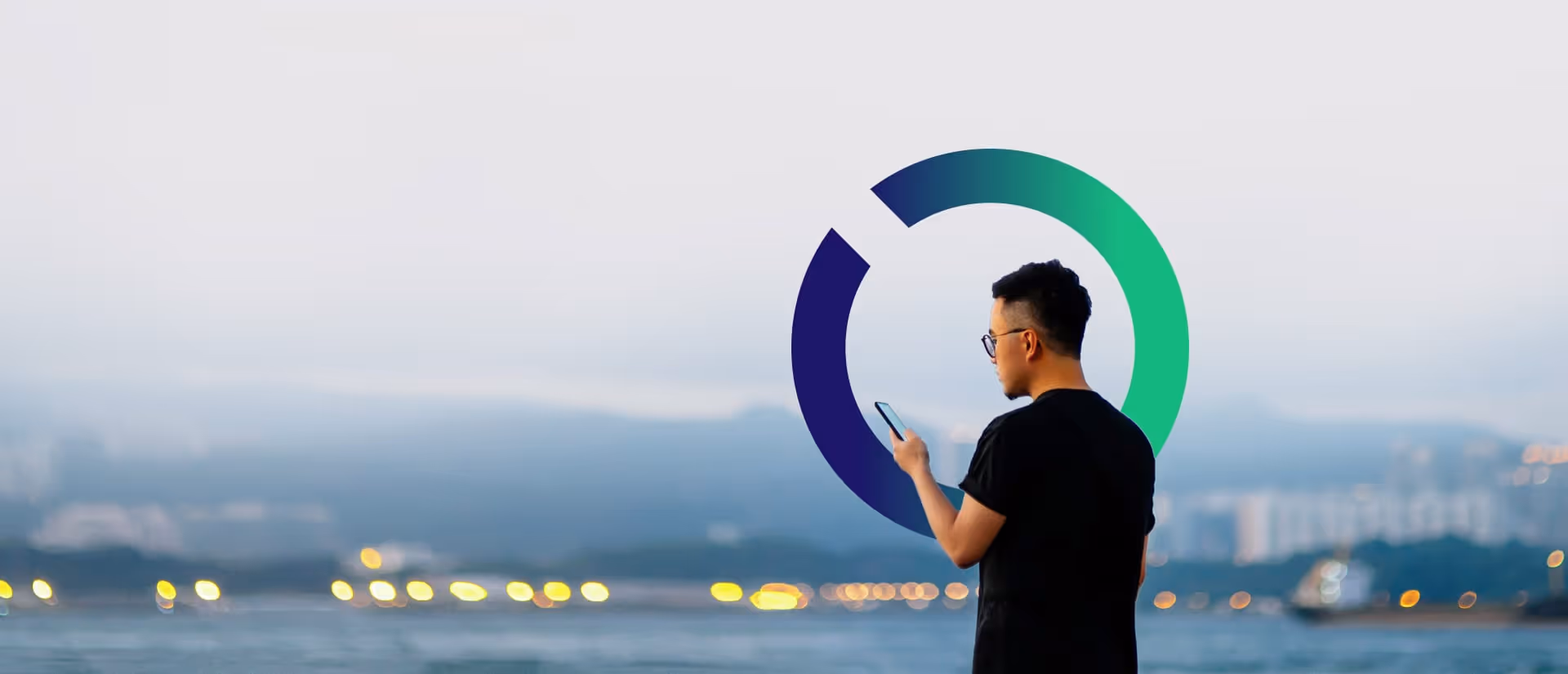 A man uses his phone, Outseer Iris behind him.