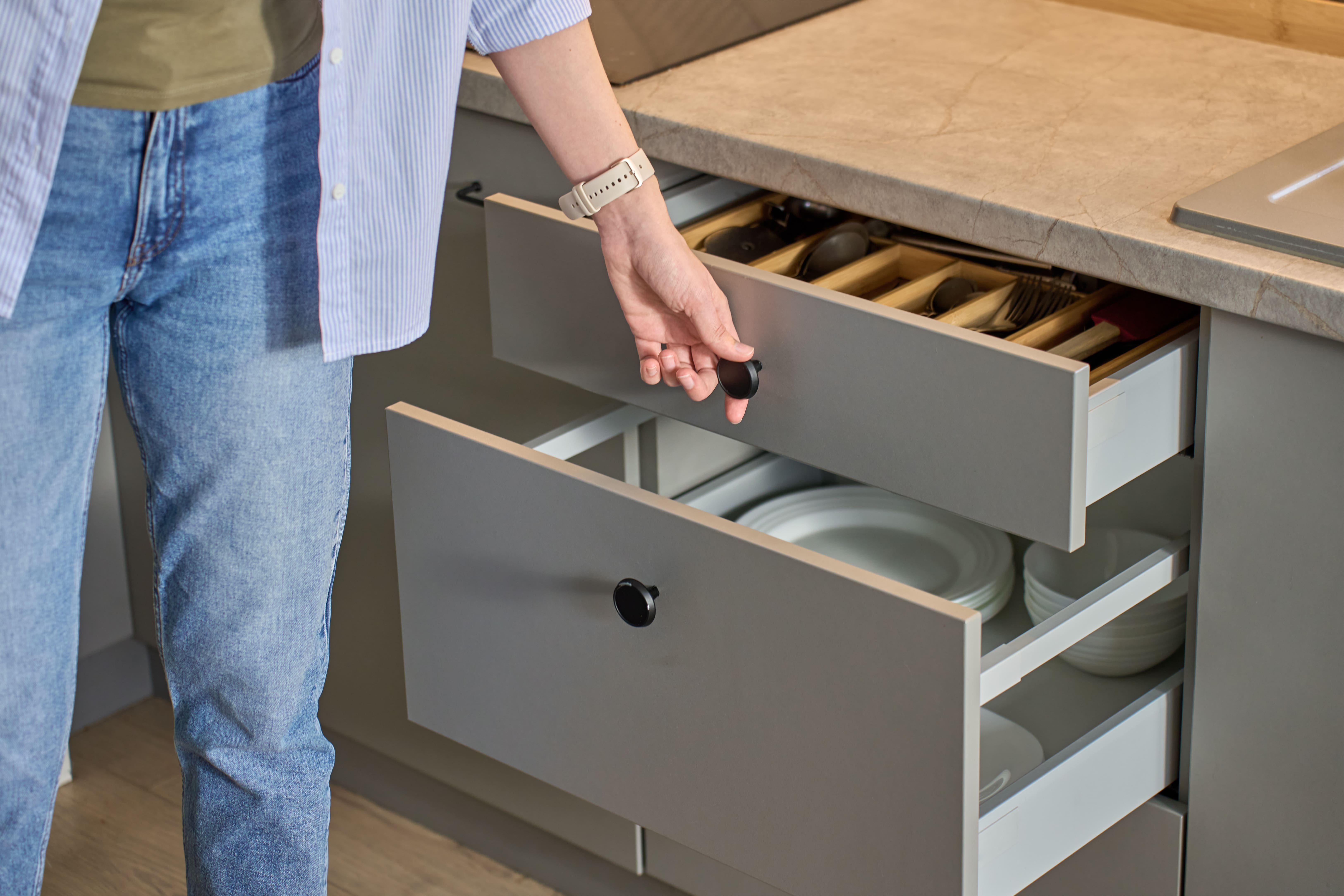 homeowner opening newly built kitchen drawers