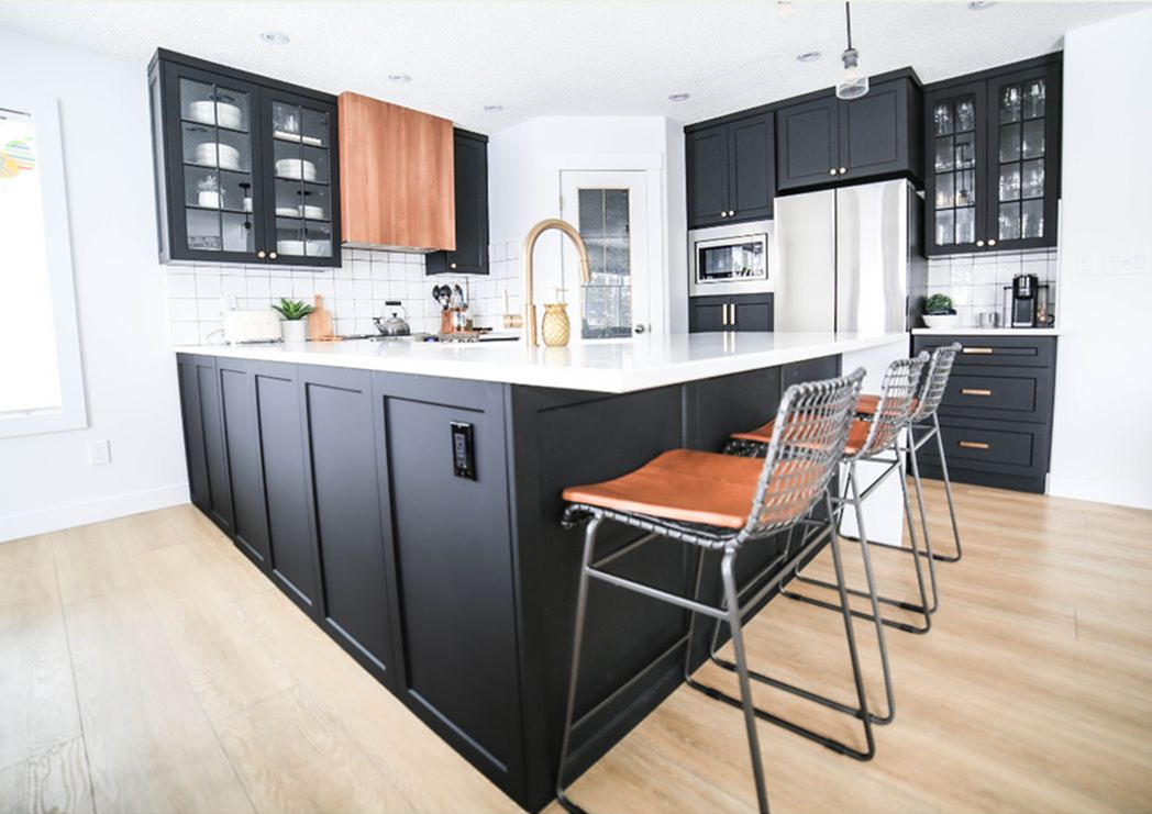 Custom dark kitchen cabinets with glass uppers and white quartz island built locally in Edmonton by Reface Magic.