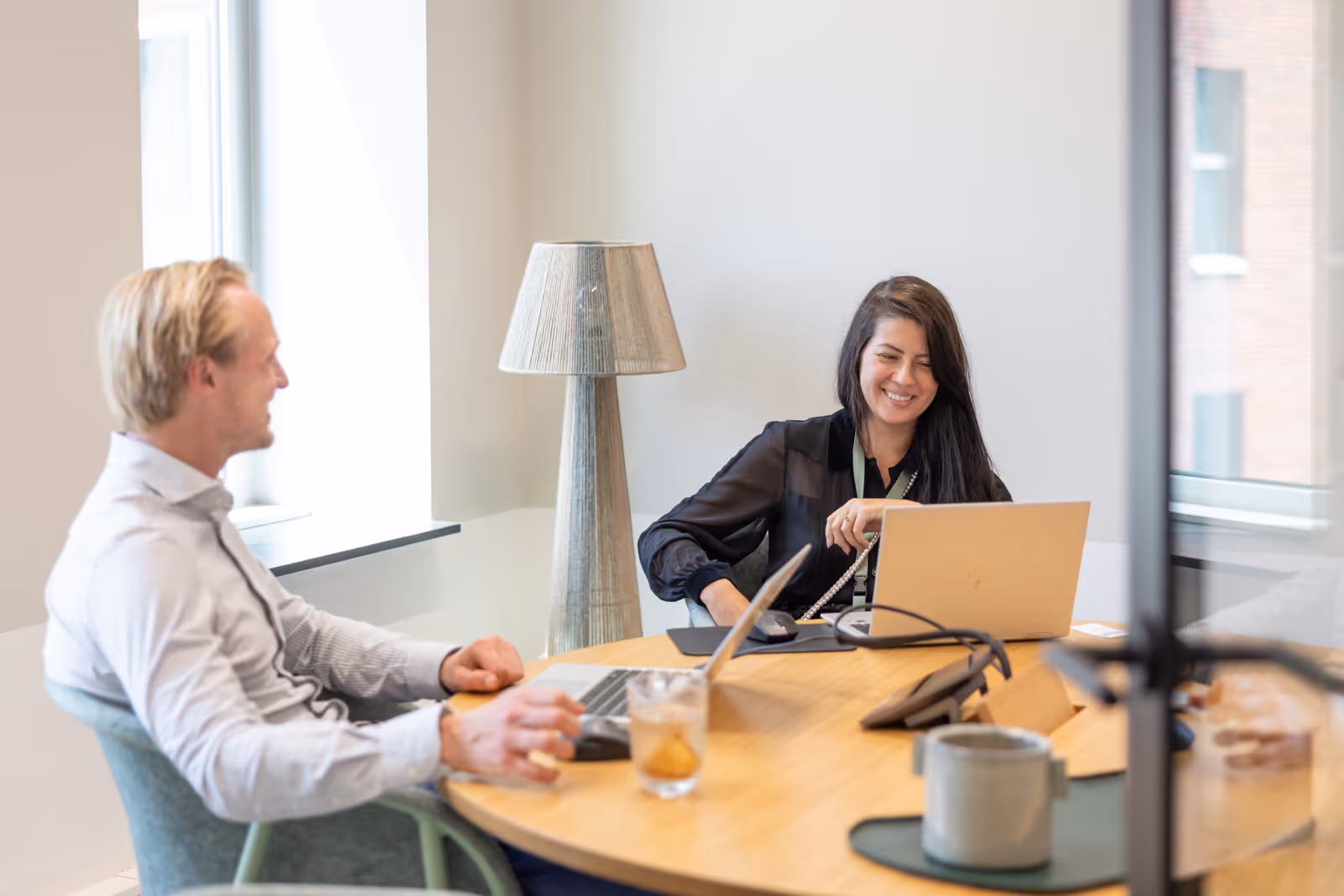 Twee collega's in gesprek aan een tafel