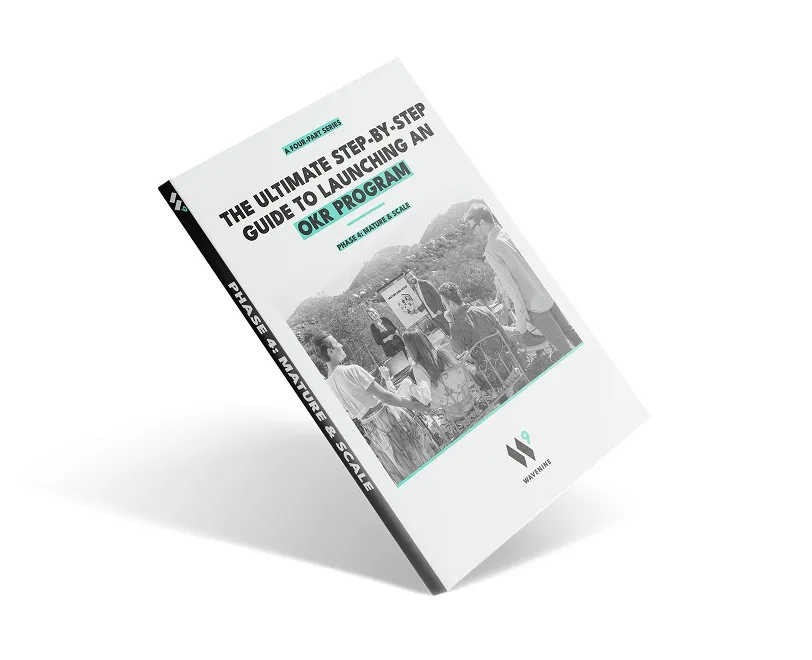 An angled view of the Wavenine ebook cover for "Phase 4: Mature & Scale," the final installment of the four-part series on launching a successful OKR program.