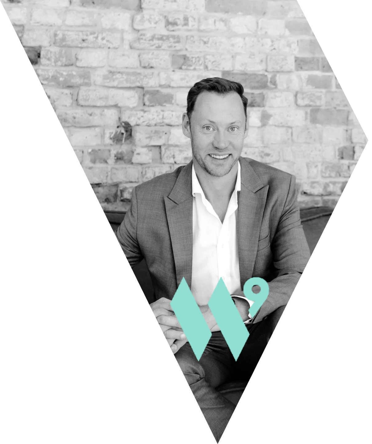 Philipp Schett, founder of Wave Nine, seated on a sofa in front of a brick wall