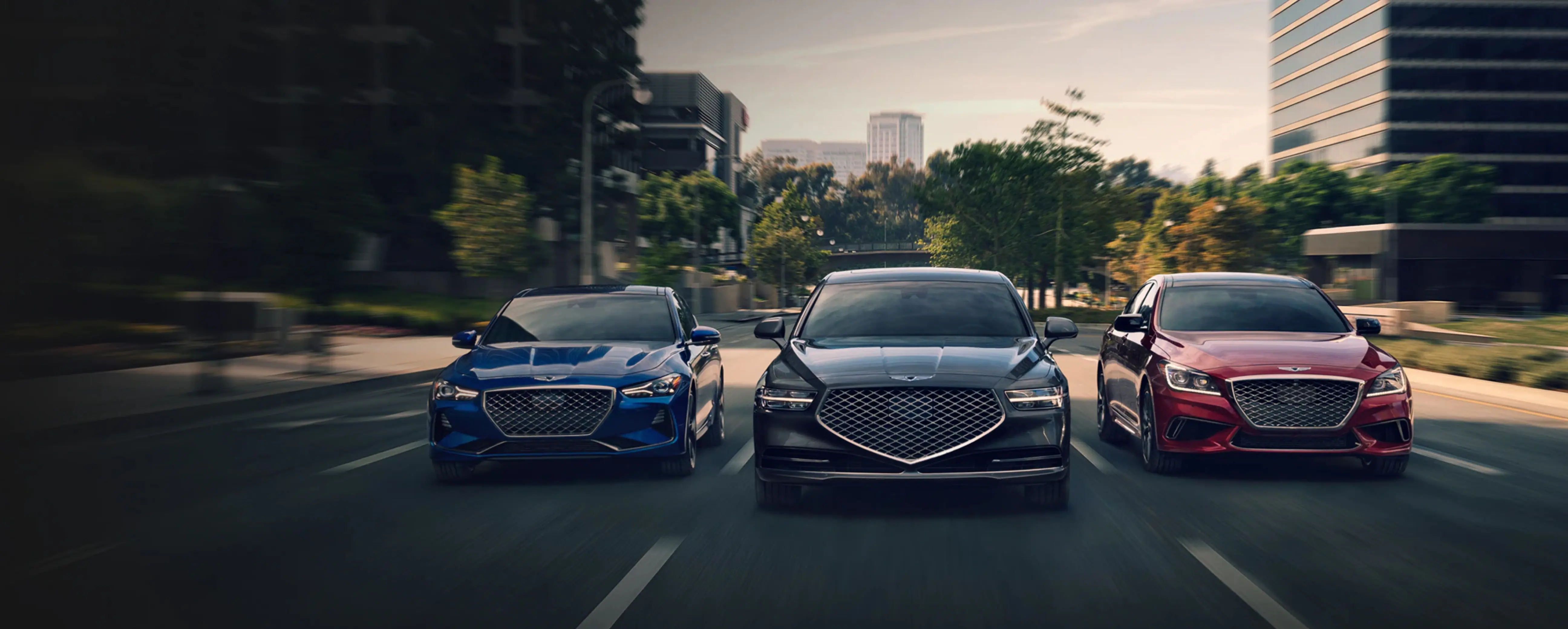 Three Genesis vehicles driving side by side on the road
