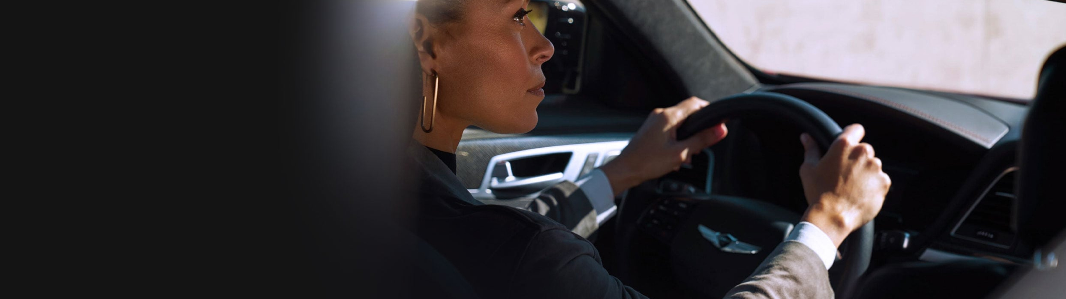 Woman driving a Genesis vehicle