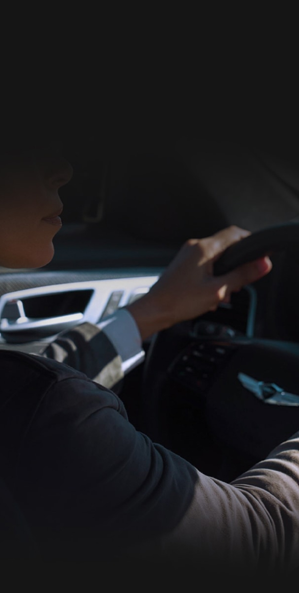 Woman driving a Genesis vehicle