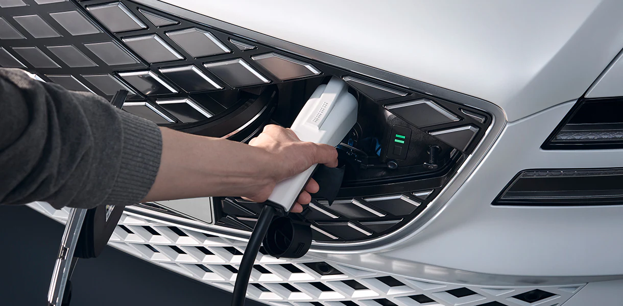 Electrified G80 charger being plugged in by driver