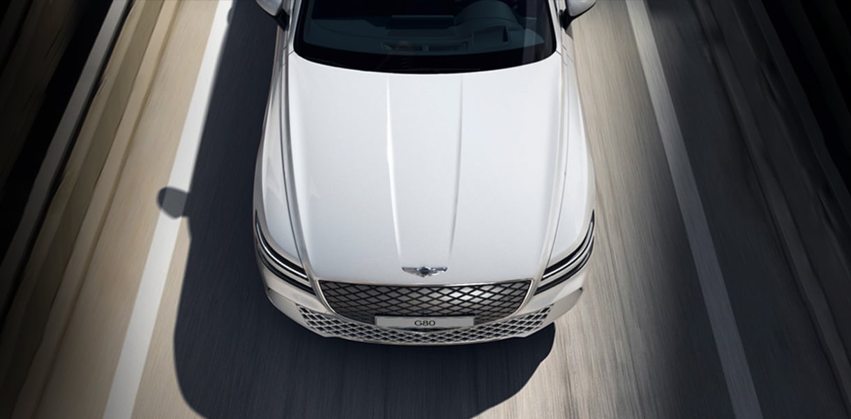 White Electrified G80 driving on highway