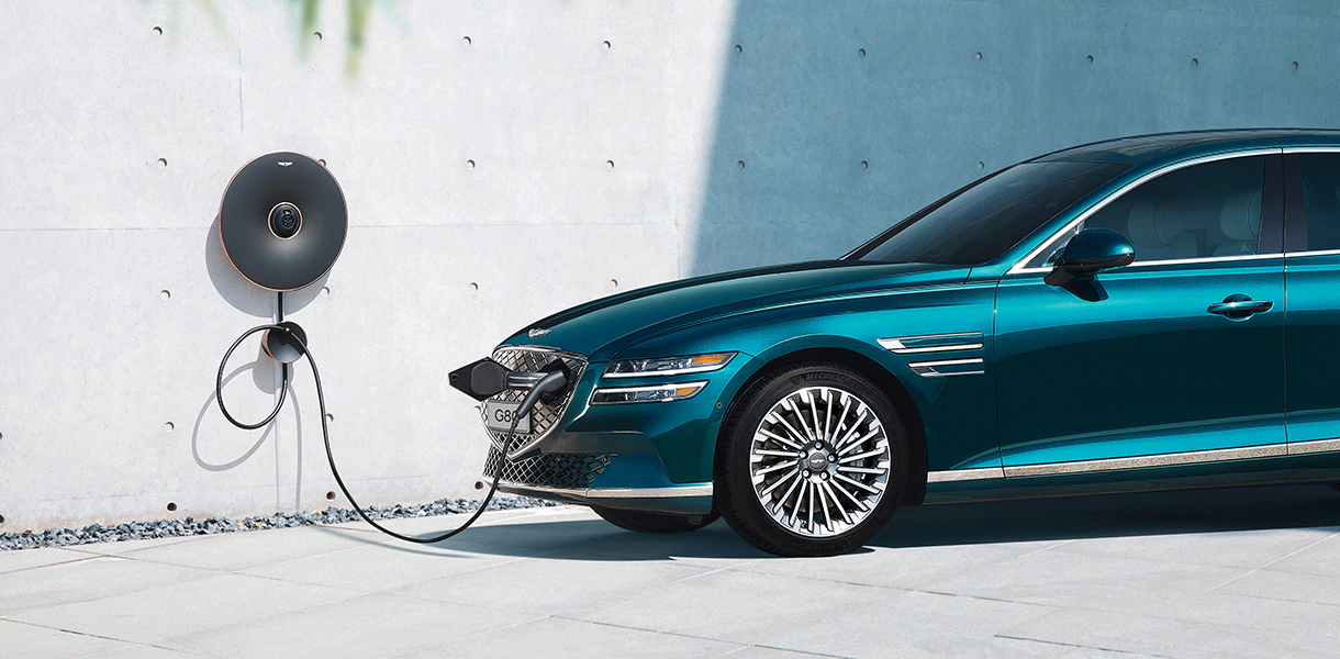 Front 3/4 view of Electrified G80 plugged in and charging